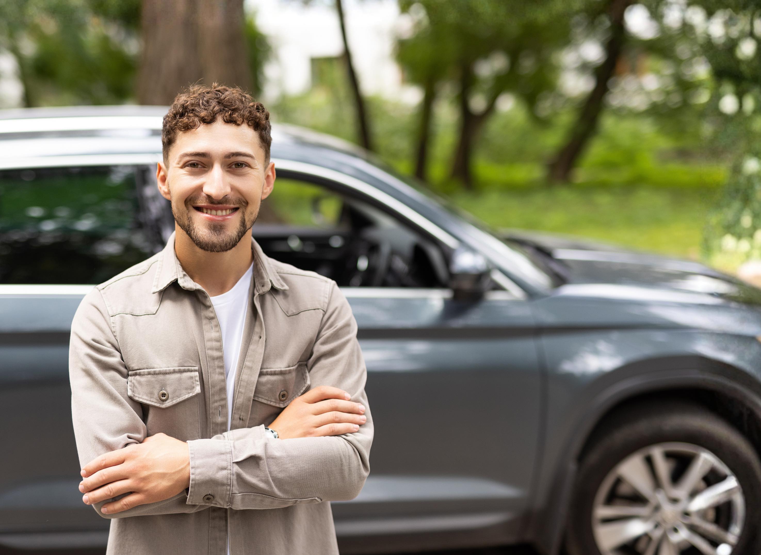 happy man in front of new car